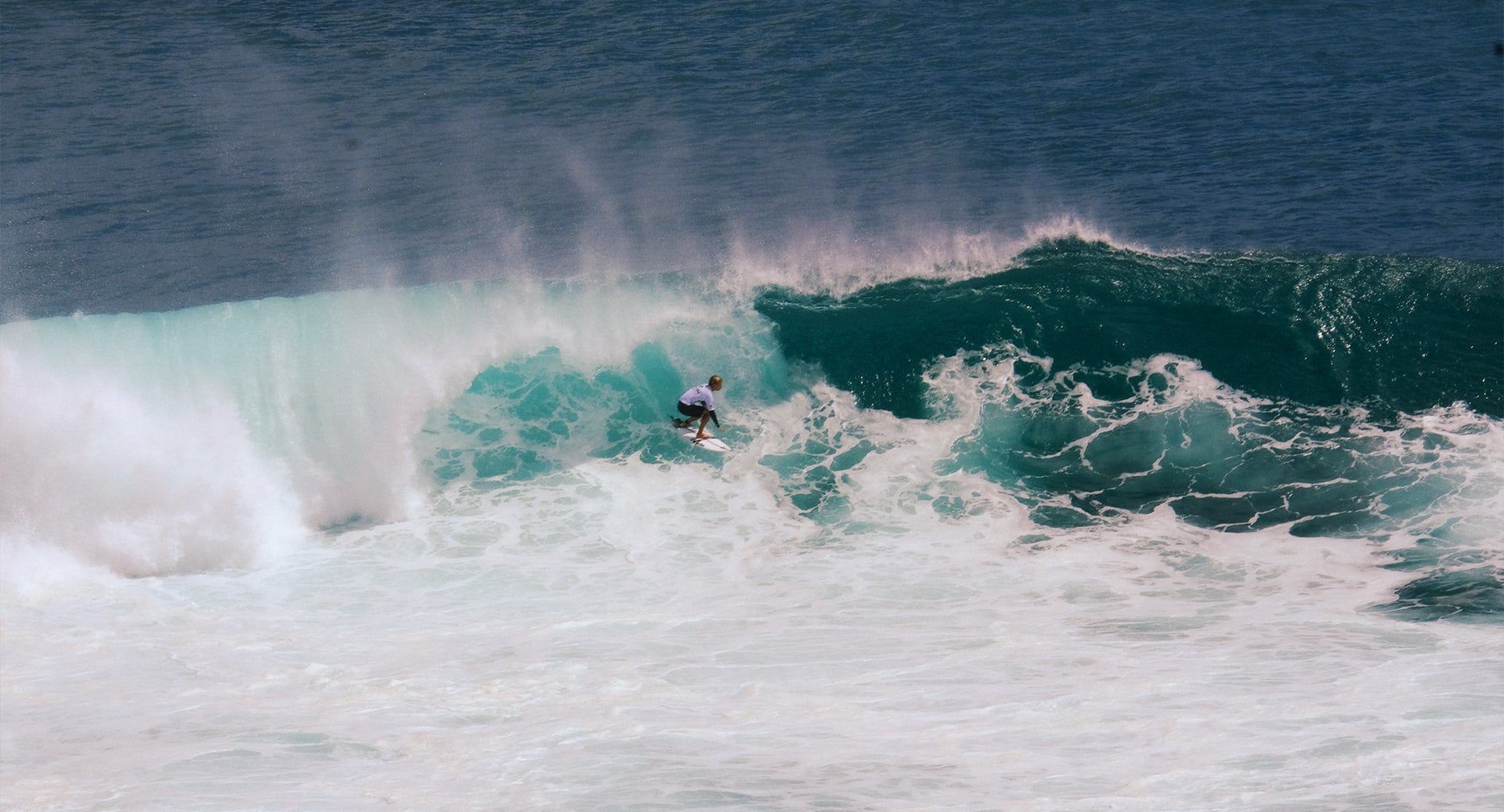 Surfing the reef below the cliff