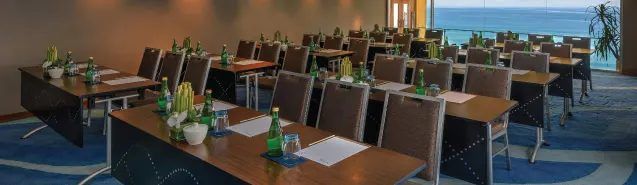 Bali Biru set classroom-style, with the ocean beyond its glass doors